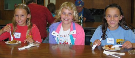 Smiling children enjoying the food