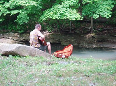 playing guitar by the creek